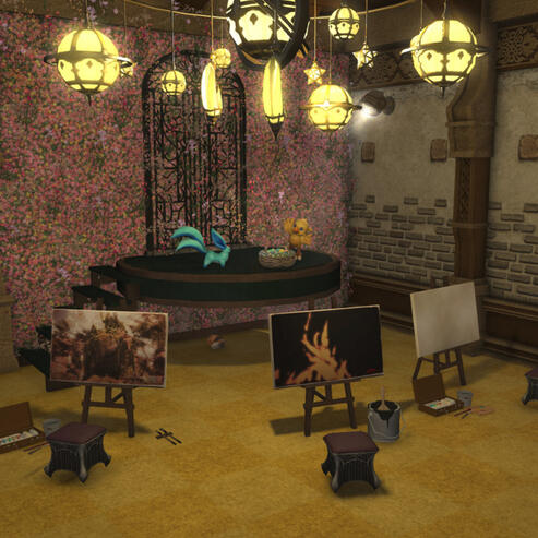 Final Fantasy 14 screenshot: Small house basement, area with a round floating stage with a carbuncle and a chocobo plushie on top. A flower covered wall and a metal gate are right behind it. In front of the stage are three painting easels.
